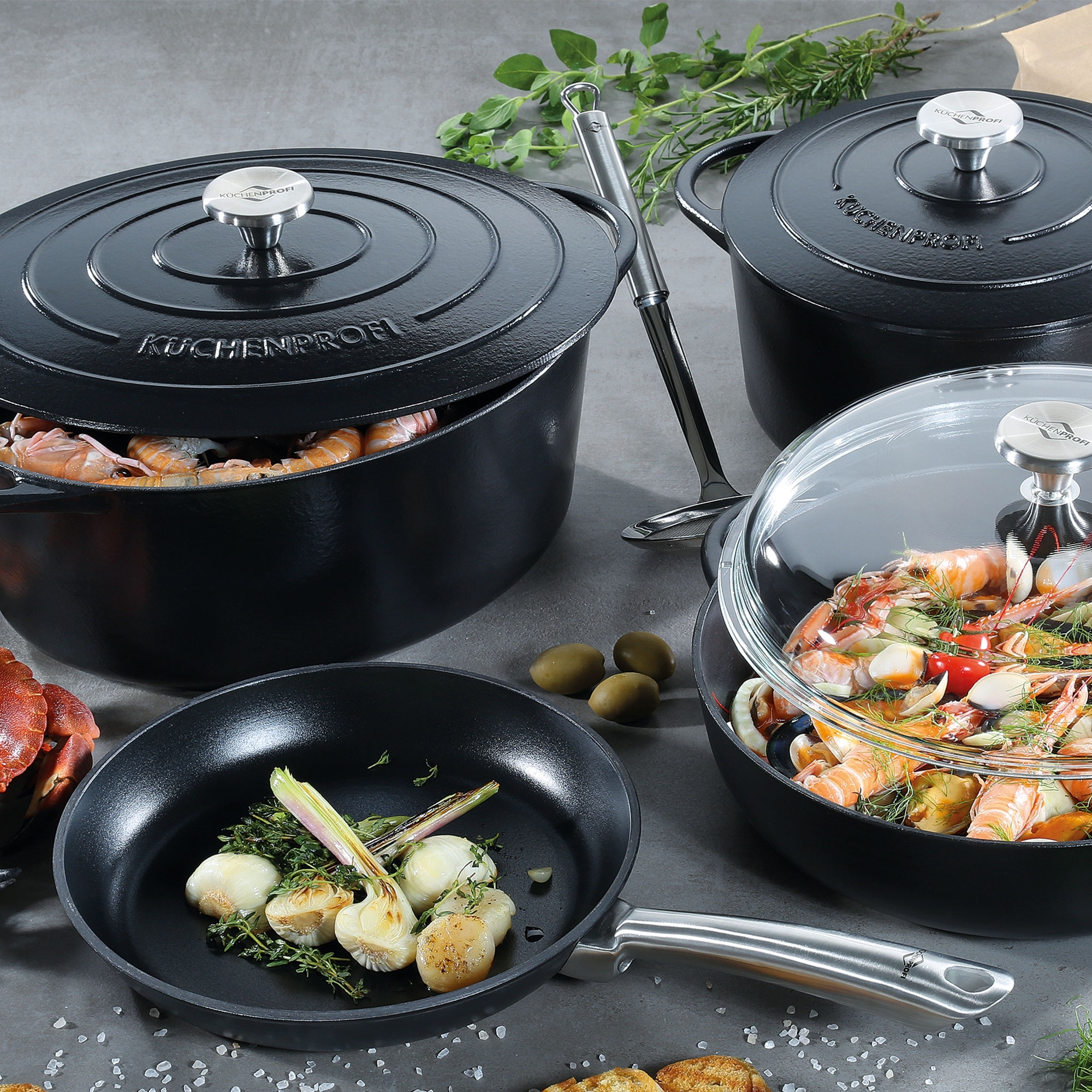 Black cast iron pot and pan set with food
