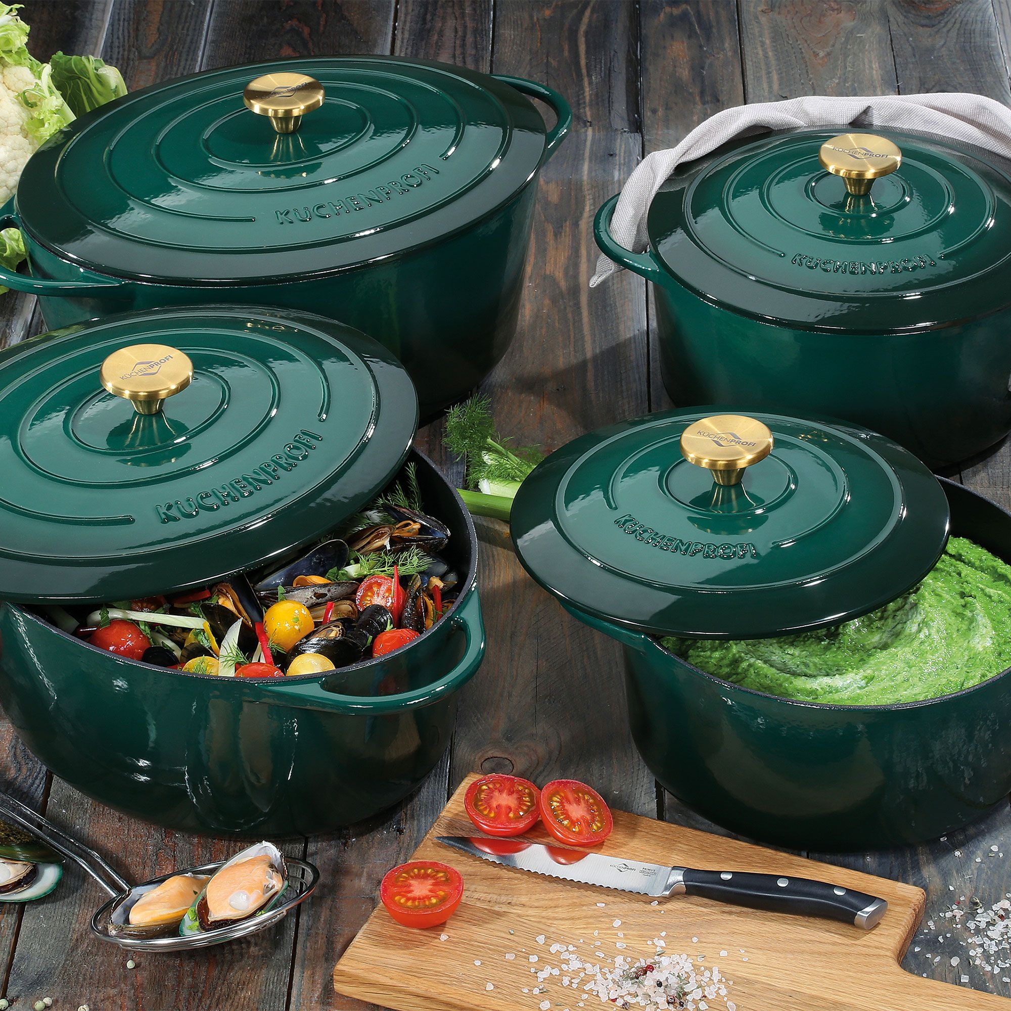Green cast iron casserole pots with gold knobs