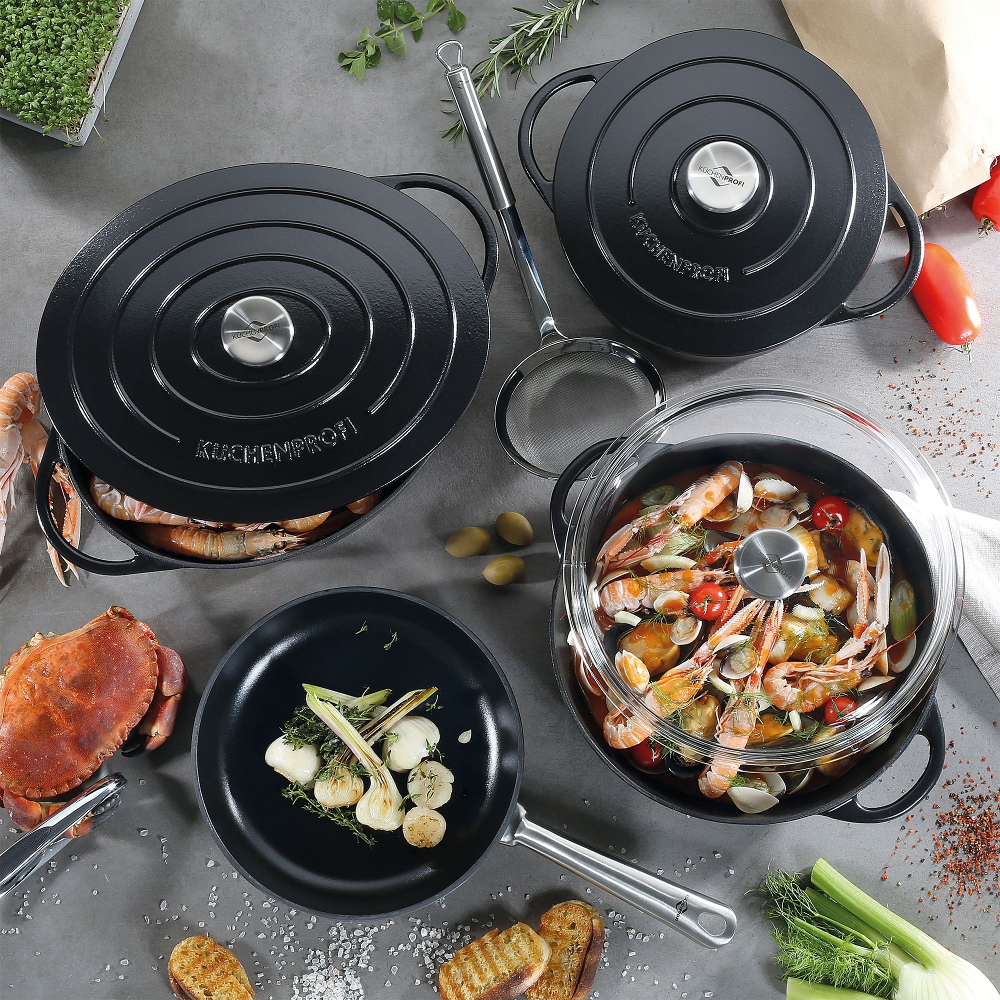 Black cast iron cookware set with seafood
